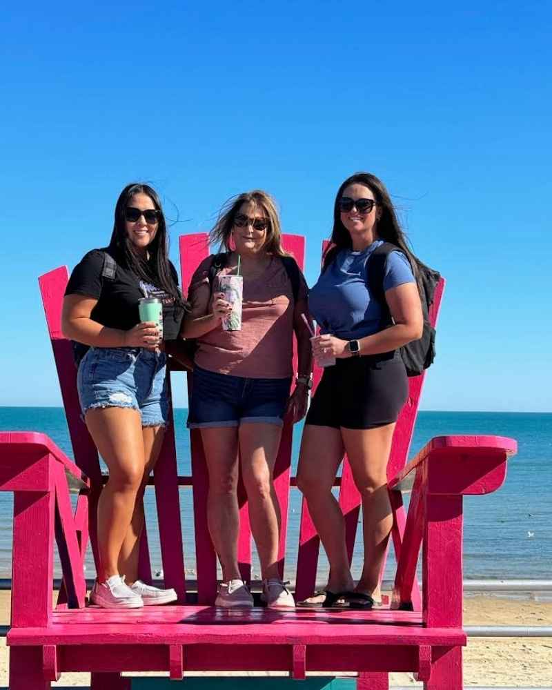 Guests relaxing under a beach palapa